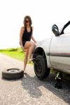 6483993-sexy-brunette-aggressively-kicking-the-wrench-to-tighten-the-nuts-of-a-flat-tire-she-just-replaced.jpg