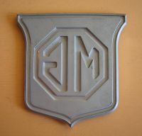 MGB_BL_Part_ARA_2148_Grill_Emblem_NOS_Reverse_Side_Reverse_Painting_Final_Coating_Detail.jpg